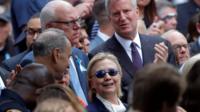 US Democratic presidential candidate Hillary Clinton and New York Mayor Bill de Blasio (R) attend ceremonies to mark the 15th anniversary of the September 11 attacks at the National 9/11 Memorial in New York, New York, 11 September