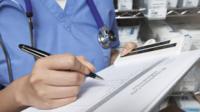 A nurse with a clipboard