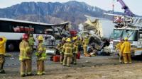 This photo provided by KMIR-TV shows the scene of crash between a tour bus and a semi-truck crashed on Interstate 10 near Desert Hot Springs, near Palm Springs, in California"s Mojave Desert Sunday, Oct. 23, 2016.