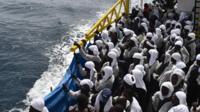 Migrants wait aboard rescue ship "Aquarius" as they arrive in the port of Cagliari, Sardinia