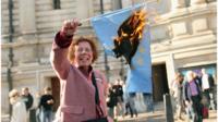Hazel Prowse burns an EU flag outside the Methodist Central Hall on October 22, 2011 in London, England, following a campaign meeting calling for a UK referendum on membership of the EU