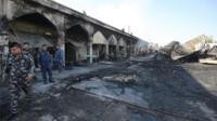 Iraqi policemen at scene of attack in Balad (08/07/16)