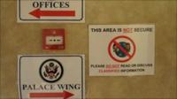 Signs warning against classified conversations in non-secure areas