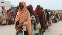 Hungry women and children queue up for food at a camp in Somalia's capital Mogadishu
