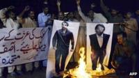 Pakistani protesters burn the photographs of former Pakistani cricketers Salman Butt and Mohmmad Asif during a protest in Multan on November 3, 2011.