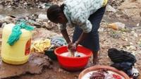 Woman washing clothes in the Kibera slum of the Kenyan capital, Nairobi