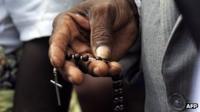 Angolan man with a crucifix during the Pope's visit to Luanda in 2009