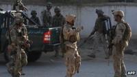 Afghan soldiers patrol a street