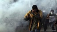 Protesters flee from tear gas fired by riot police and army soldiers during clashes at Abbasiya Square, near the Defence Ministry, in Cairo May 4