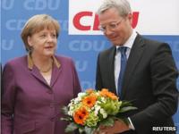 Chancellor Angela Merkel and Environment Minister Norbert Roettgen after election defeat in North Rhine-Westphalia