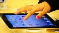 A customer tests out an iPad at a store in New York