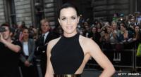 Cyclist Victoria Pendleton wearing a black dress and posing for the camera