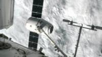 SpaceX Dragon being captured by robotic arm