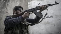Oct. 24, 2012 A Free Syrian Army fighter from Liwwa Al-Tawhid carries out a military operation in the Karmal Jabl neighborhood, Aleppo, Syria