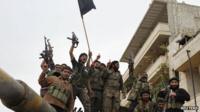 Members of the Free Syrian Army celebrate on a tank that belonged to pro-government forces after they took over the site from them early Monday in Salqin city in Idlib October 22, 2012.