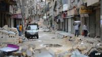 Piles of rubbish litter the streets of Aleppo