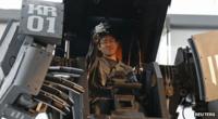 Robotics expert Watanaru Yoshizaki demonstrates how to operate the arm of a giant "Kuratas" robot at an exhibition in Tokyo November 28, 2012.