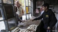 Men buy bread in the old city of Damascus on 8 November