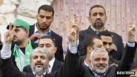 Hamas chief Khaled Meshaal (L) and senior Hamas leader Ismail Haniyeh flash victory signs upon arrival at a rally marking the 25th anniversary of the founding of Hamas, in Gaza City