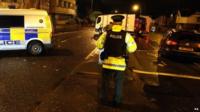 Police seal off a road in Belfast.