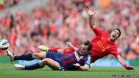 Dean Whitehead of Stoke City tackles Luis Suarez of Liverpool