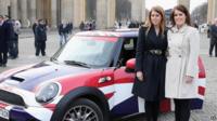 The princesses stood next to their Mini which is decorated in Union flag livery