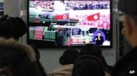 People in Seoul watch TV news showing file footage of a North Korean rocket carried during a military parade. Photo: 24 January 2013