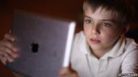 A young boy uses an iPad