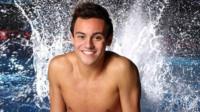 Tom Daley in front of a swimming pool