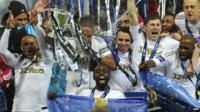 Swansea City players celebrate with Capital One Cup final trophy.