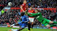 Chelsea's Demba Ba tackling with Manchester United's goalkeeper David de Gea and Manchester United's Rio Ferdinand