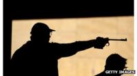 Asgeir Sigurgeirsson holds a firearm