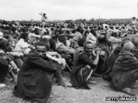 African rounded up in Kairobangi, Nairobi, by police searching for Mau Mau insurgents (27 April 1953)