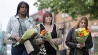 Women carry flowers