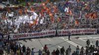 Russian opposition protesters some holding portraits of political prisoners shout anti-Putin slogans