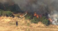 Firefighter tackles grass fire
