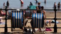 Sunbathers on deckchairs