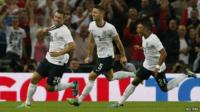 England's Lambert celebrates scoring against Scotland with teammates Cahill and Oxlade-Chamberlain