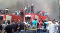 Emergency personnel gather at the site of a car bomb