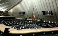Iranian MPs listen to a speech by President Hassan Rouhani before electing ministers to form a cabinet on 15 August, 2013 during a parliament session in Tehran.