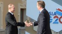 Russian President shaking hands with David Cameron, UK PM