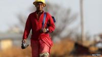 A miner walks as he returns from work outside Driefontein Gold Mine,70 km (43 miles) west of Johannesburg, 4 September 2013