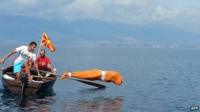 Bulgarian Jane Petkov tied up in a bag jumps in Lake Ohrid. Photo: 10 September 2013