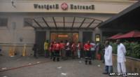 Medics wait outside a shopping centre