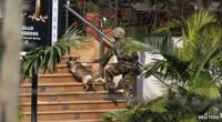 A soldier with an army dog walk up the steps to the shopping centre