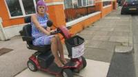 A woman on a mobility scooter