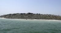 People walk on an island that reportedly emerged off the Gwadar coastline in the Arabian Sea