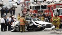 Rescue personnel surround a damaged police vehicle following the shooting incident at the US Capitol