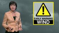 A weather reporter with a Wind warning