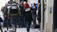 Police arriving at Liberation's Paris offices to investigate the shooting (18 November)